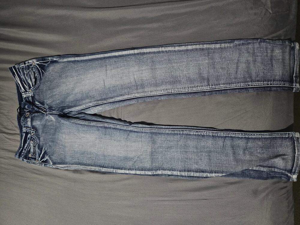 Dark wash denim jeans with contrast stitching five pocket zip fly